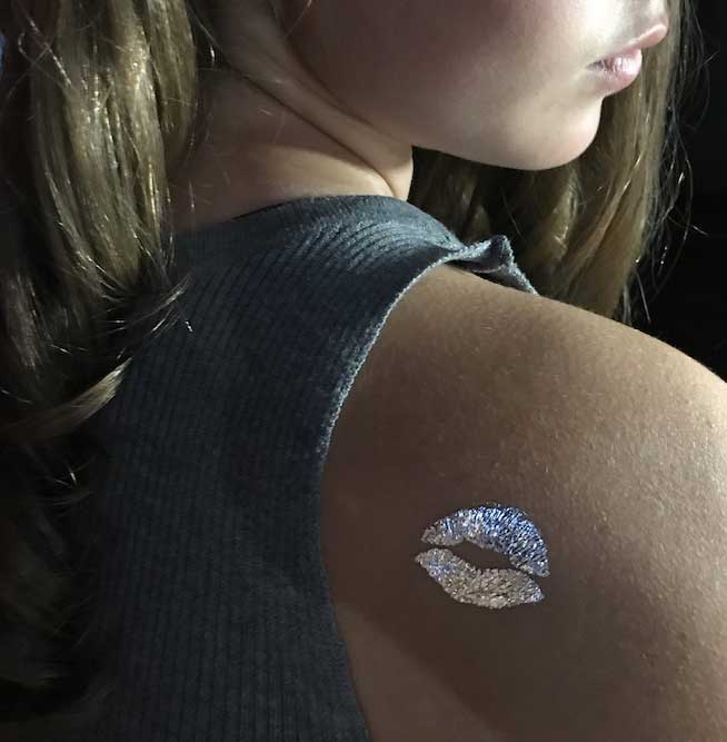 A person with a bandage on their upper arm after receiving a vaccine or injection.