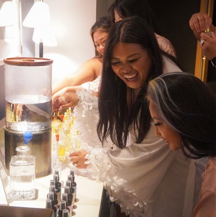 two women mix fragrances happily as part of a DIY Spa Product country club event