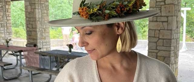 a woman shows off her handmade flower crown at a country club event
