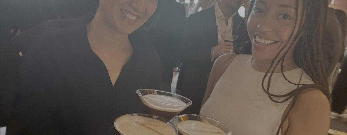 Three colleagues enjoy espresso martinis with logos of the event host thanks to Laine Too's drink printing services in Chicago.