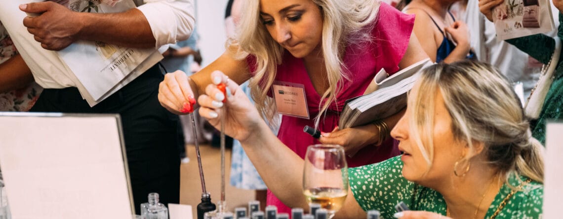 Event participants enjoy mixing and matching fragrances at a custom room spray making experience.