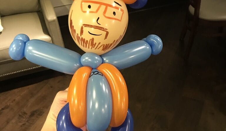 balloon art of a male employee at a corporate event